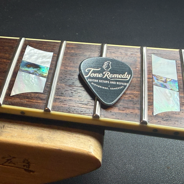 Professional guitar fretwork and levelling Close-up of guitar frets during specialist fret levelling and dressing work