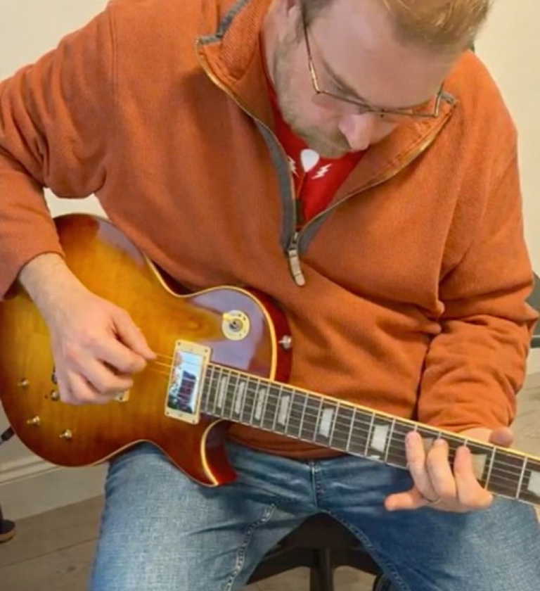 Ben carrying out a final play test before signing off Guitar pickup final testing by hand during play-testing at the bench