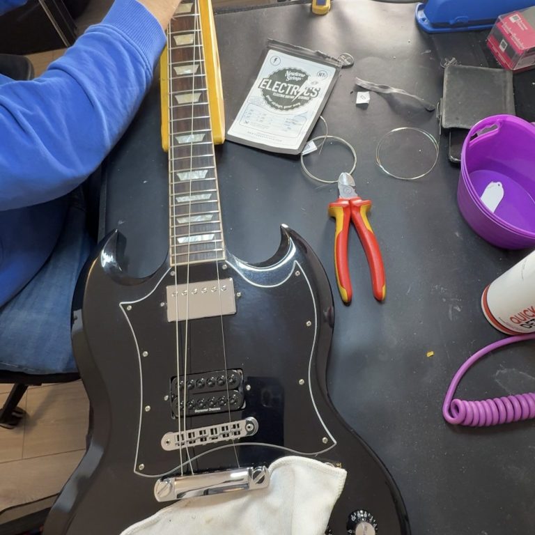 Electric guitar setup in progress Electric guitar on the bench during a full setup, with tools laid out for adjustments and checks